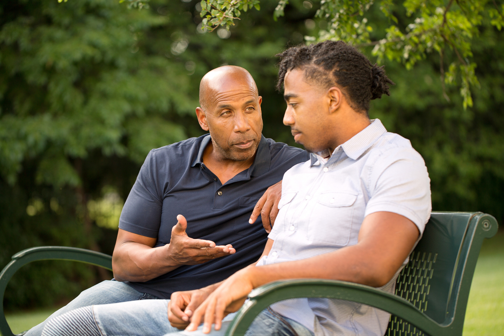 Mature man mentoring and giving advice to a younger man.