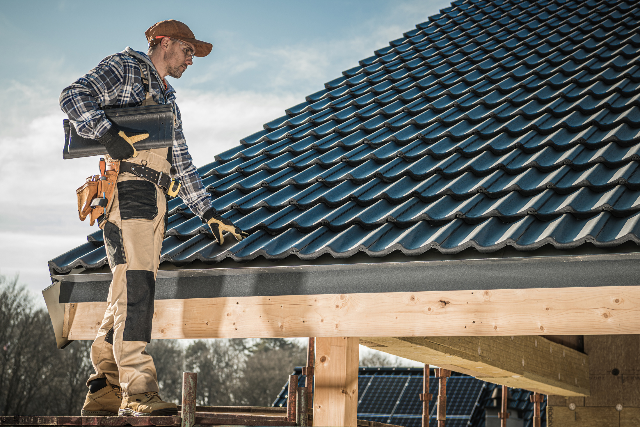 Carpenter Installing Roof Shingles