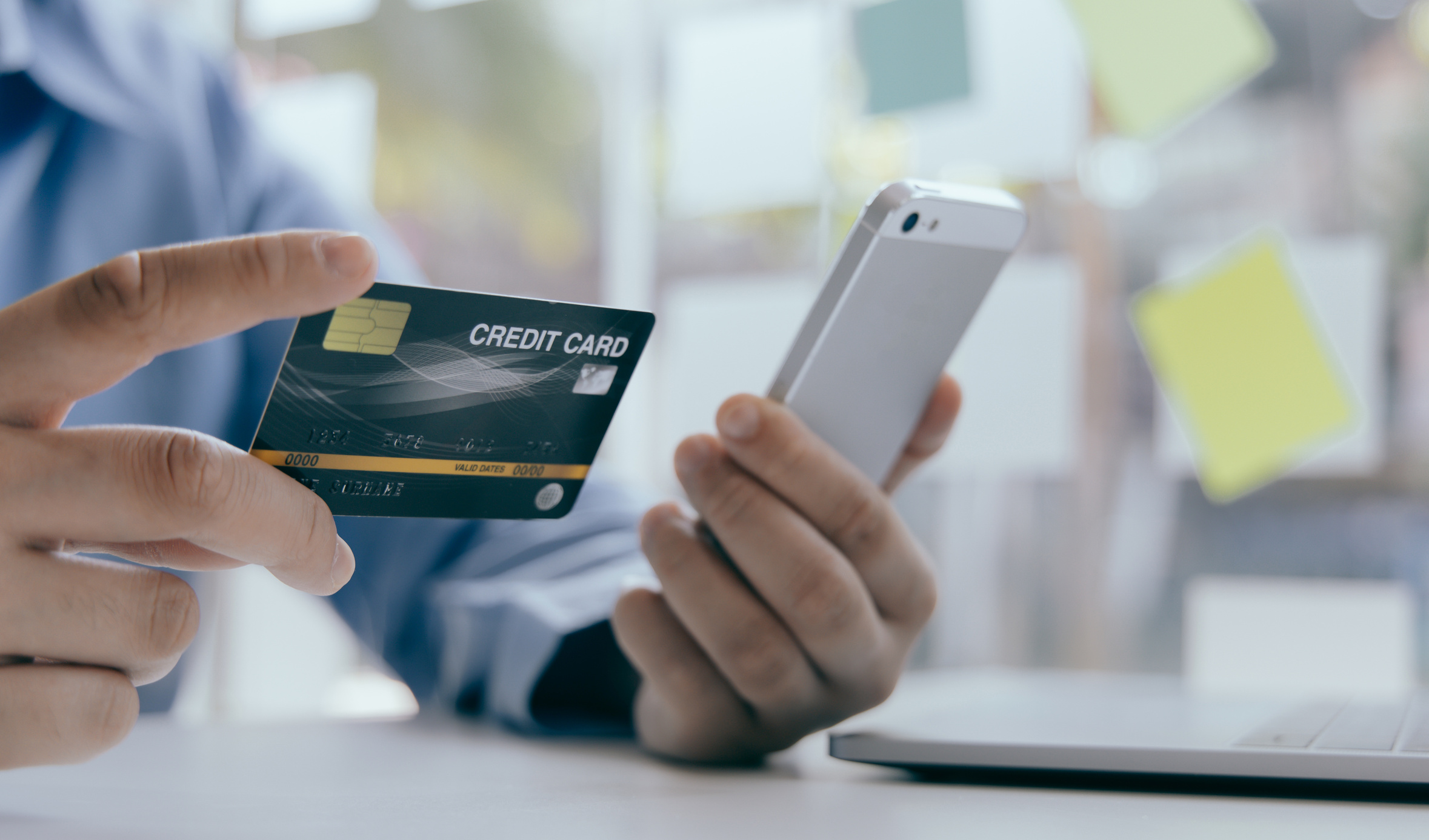 Man Holding Credit Card and Phone