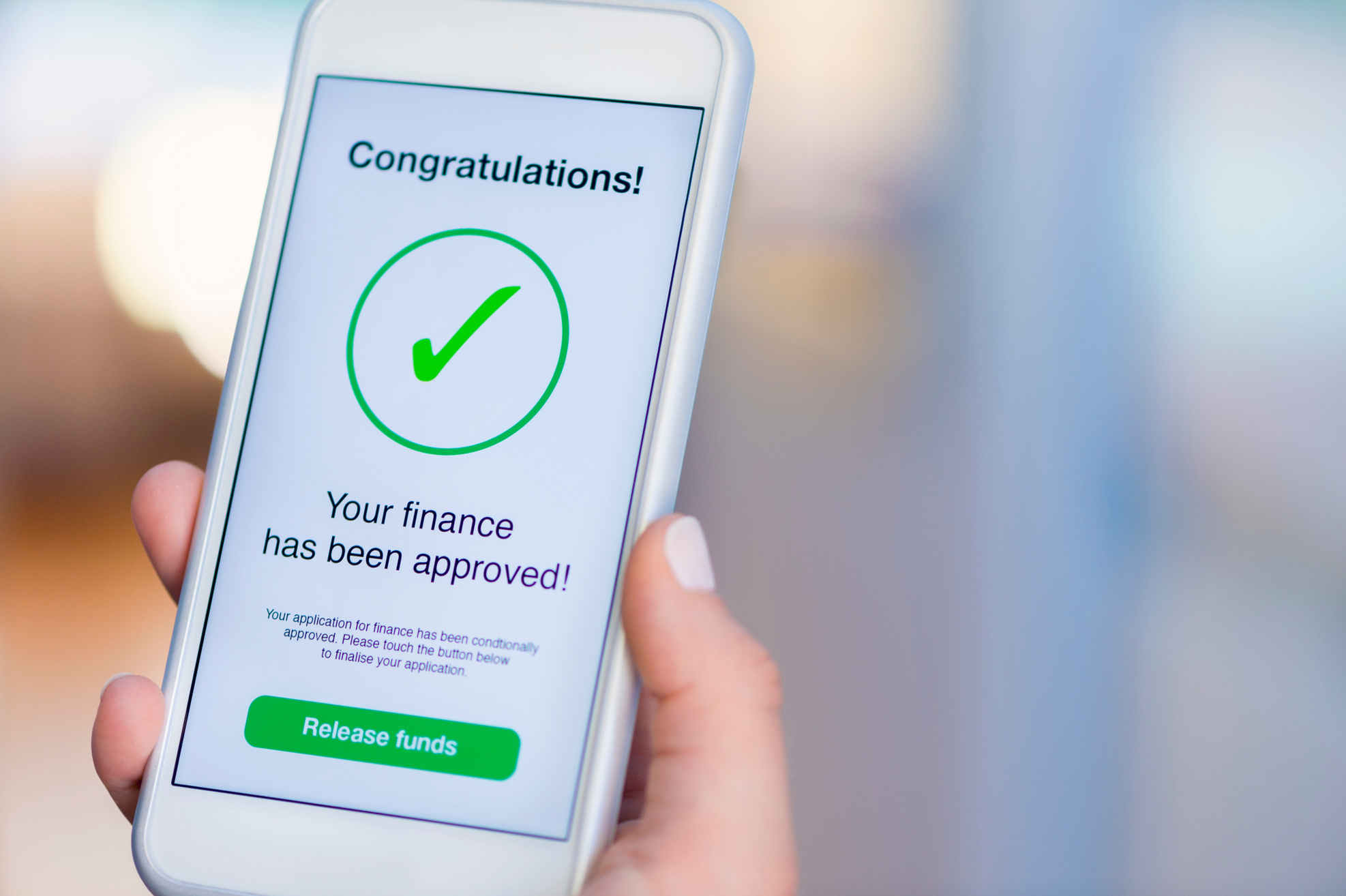 Mortgage Loan approval on mobile phone in a house.