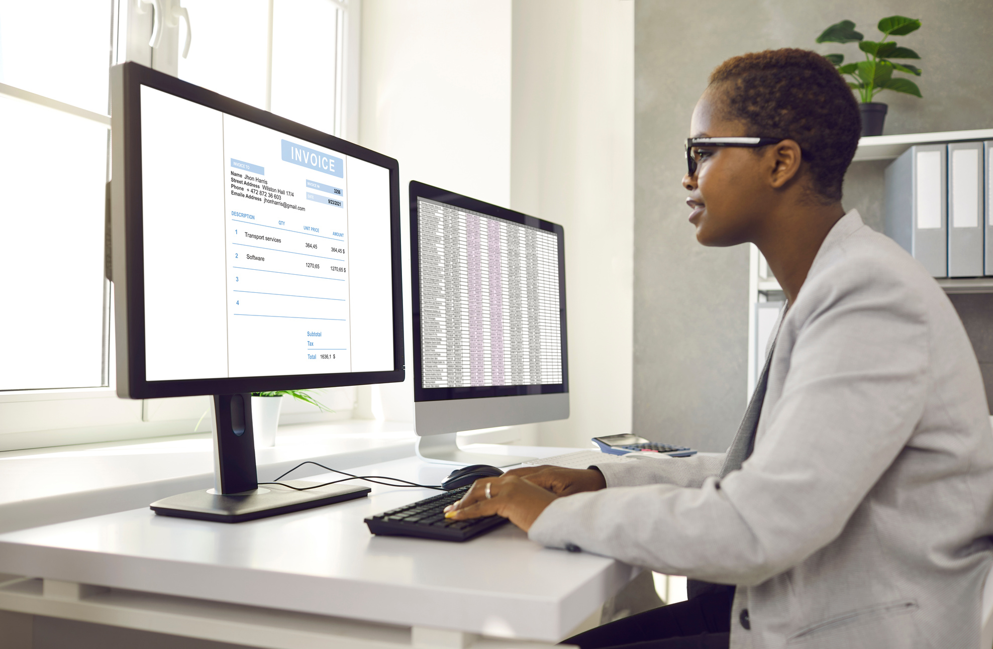 African American Female Accountant Working with Software for Electronic Invoices on Computer.